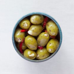 Garlic stuffed Provençale olives in a bowl